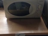 a microwave sitting on top of a wooden counter