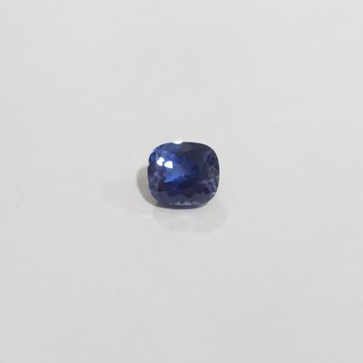 une pierre de saphir bleu sur une surface blanche