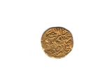 a close up of a gold coin on a white surface