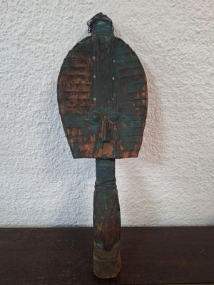 a wooden paddle that is sitting on a table
