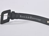 black leather belt with a metal buckle that says lines at a distance