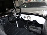 a black and white photo of a car inside of a garage