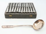 six spoons and a box of silverware on a table