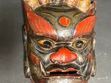 an image of a wooden mask on a table