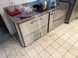 a stainless steel counter top with two drawers in a kitchen
