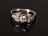 a close up of a diamond ring on a black surface