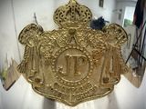 a gold belt buckle with angels and a crown on it