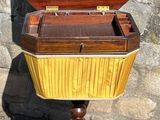 a wooden box sitting on a stand with a wooden top