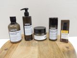 a wooden table with a lot of different types of skin care products on it