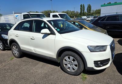a white car parked in a parking lot with other cars