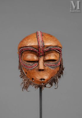 an image of a wooden mask on a stand