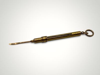 an old brass spoon with a handle on a white background