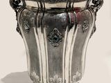 a silver vase that is sitting on a table