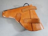 a close up of a leather holster on a white surface
