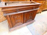 a large wooden cabinet with drawers and drawers on it