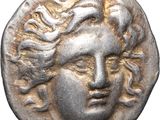 a silver coin with a woman ' s face on it