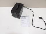 a black power supply sitting on a white table