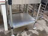 a stainless steel table with a metal shelf on it