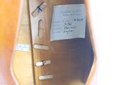 a piece of paper taped to the back of a guitar