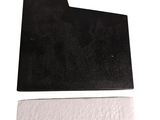 a black piece of paper on a white surface