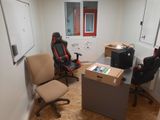 two chairs and a desk in a small room