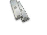 two pieces of metal on a white surface