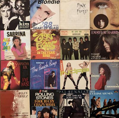 a lot of music covers on the wall of a room