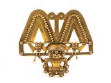 a close up of a gold brooch with a bird on it