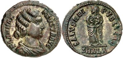 a silver coin with a bust of a woman and a bust of a man on it