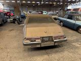 a car that is parked in a garage next to other cars