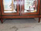 a wooden cabinet with two doors and a mirror on it