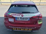 a red car that has a sticker on the back of it