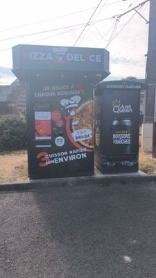 two vending machines sitting on the side of the road