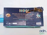 a box of toothpaste on a table with a tooth brush