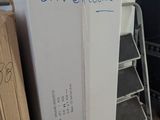 a refrigerator in the corner of a room with a sign on it