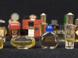 many different types of perfume bottles lined up on a table