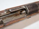 an old gun with a wooden barrel and a metal handle
