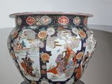 a vase that is sitting on a stand on the floor