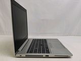a laptop that is sitting on a white surface