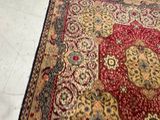 a red and gold rug on the floor in a room