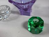 several different colored glass pieces are sitting on a table
