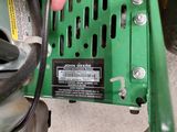a close up of a person ' s hand holding a green machine