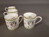 three coffee cups with floral designs on them sitting on a table