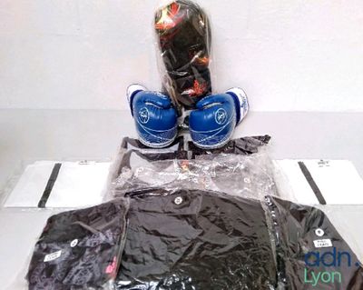 a pair of boxing gloves, a shirt and a pair of boxing gloves on a table