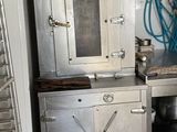 a kitchen with a stove, sink, and oven in it