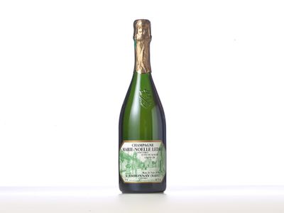 an image of a bottle of champagne sitting on a table