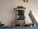 a forklift sitting on a pallet in a room