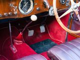 a steering wheel and dashboard of a vintage car