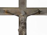 a statue of jesus on the cross with a sign above it
