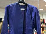 a blue shirt hanging on a metal rack in a store